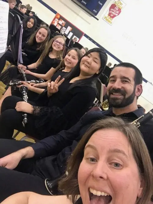 A young musician playing alongside a Denver Municipal Band member